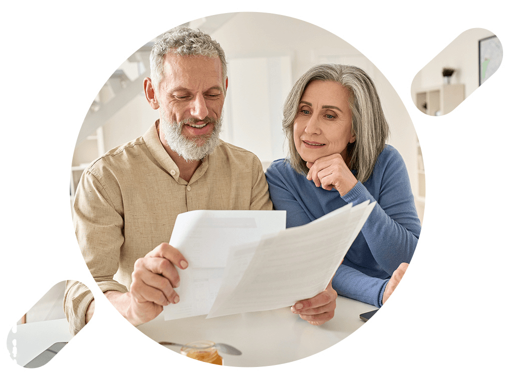 elderly couple reading several documents