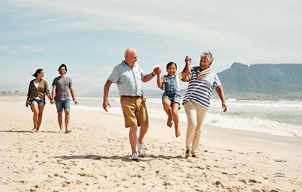 elderly couple enjoying quality time with their grandaughter at the beach